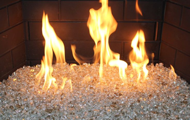 the fire is blazing and it looks like they have been made out of glass pebbles