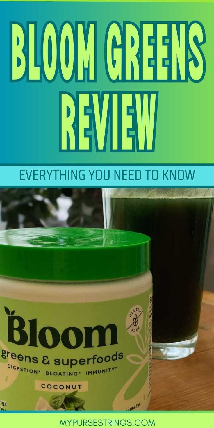 a jar of bloom green's review next to a glass of black liquid on a table