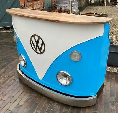 a blue and white vw bus with a wooden counter on the front is shown