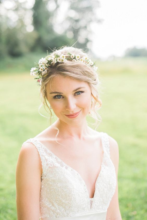 a woman in a wedding dress is holding a bouquet and posing for the camera with her eyes closed