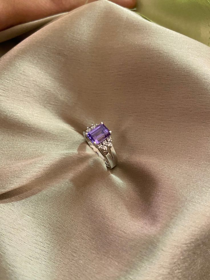 Elevate your style with our Amethyst CZ Sparkle Ring, meticulously crafted in silver and adorned with a stunning amethyst CZ stone for a luxurious and vibrant appearance. The ring also features unique 5A lab-created diamonds by CZ, adding to its high-quality and real diamond feel. Finished with 18kt gold plating and a highly-reflective rhodium polish, this ring not only dazzles but also ensures durability and prevents tarnishing. Finish: White Gold Plating Material: Silver, Alloy, CZ Stones, Amethyst Color: White, Purple Size: One Size Closure Type: NA Box Contains: 1 Ring Classic Purple Gemstone Birthstone Ring, Fine Jewelry Purple Diamond Ring With Gemstone Accents, Classic Amethyst Birthstone Ring With Accent Stones, Fine Jewelry Purple Sapphire Ring With Accent Stones, Purple Diamond Ring With Gemstone Accents, Classic Purple Birthstone Ring With Gemstone, Purple Sapphire Birthstone Ring With Diamonds, Tanzanite Birthstone Ring For Promise, Purple Birthstone Ring With Gemstone Accents