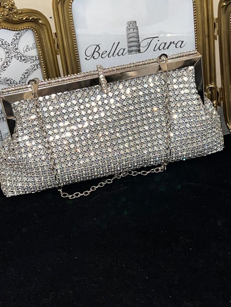 BELLA TIARA INTRODUCES OUR ELEGANT CRYSTAL PURSE COLLECTION A MUST HAVE FOR ANY SPECIAL OCCASIONAbsolutely stunning, dazzling, glamorous and elegant. Our Adora swarovski crystal clutch purse is perfect for all your essentials, soft and elegant removable chain satin lined. crystal all around, soft satin lined perfect for any size cell phonemeasures approx 8" long x 3 3/4" high. Available in silver frame setting or gold frame setting -------------------------------------- *Note processing time is Elegant Sparkling Clutch Bag, Glamorous Sparkling Evening Bag, Elegant Sparkling Formal Bags, Crystal Evening Bag With Bling For Party, Crystal Bling Evening Bag For Party, Sparkling Crystal Evening Bag, Chic Crystal Evening Bag For Weddings, Luxury Sparkling Evening Bag For Party, Elegant Crystal Bags For Formal Occasions