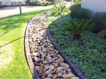 a garden with rocks and plants in it