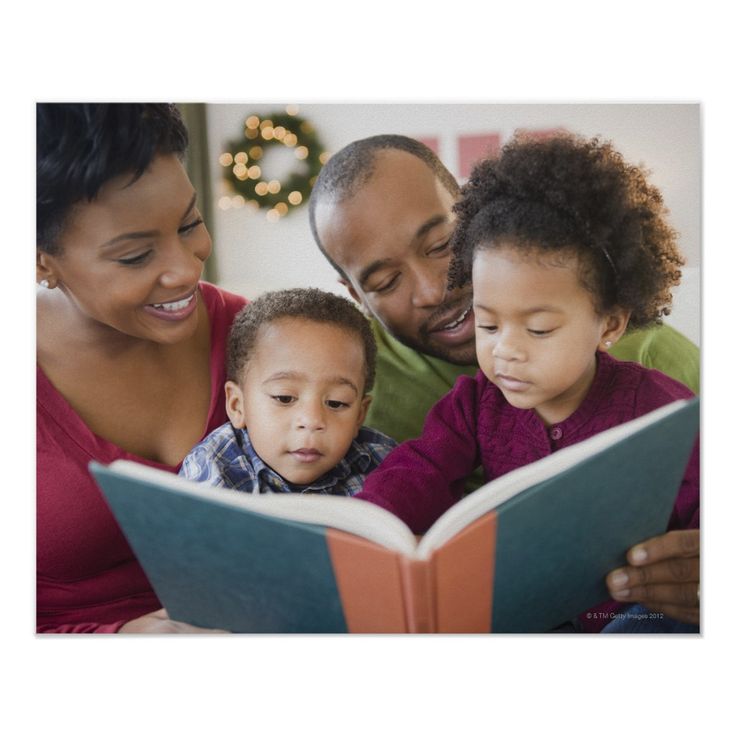 an adult and two children reading a book