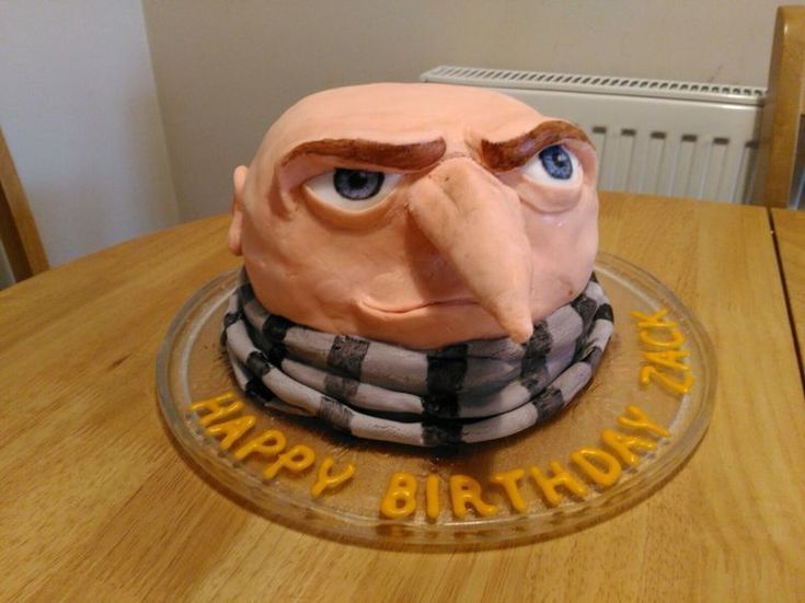 a birthday cake that looks like an angry man's head with the words happy birthday on it