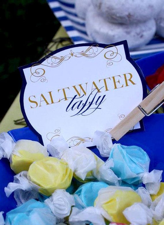 there is a sign that says saltwater taffy next to some marshmallows