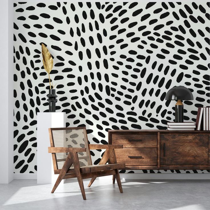 a room with black and white wallpaper that has spots on it