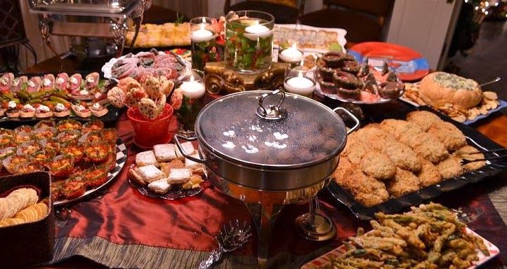 a table filled with lots of food and candles