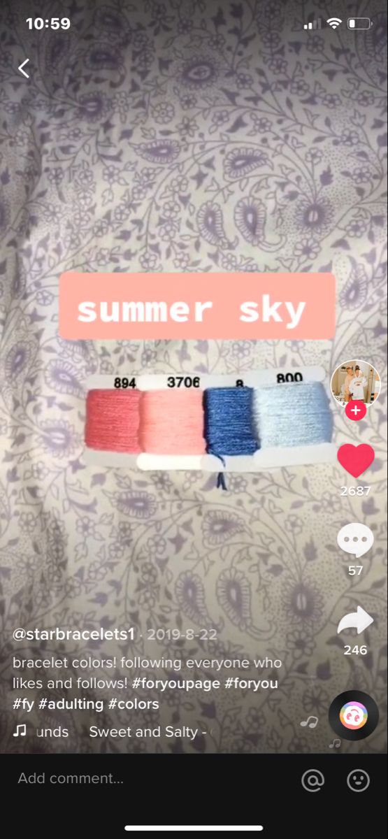 an iphone screen with the text summer sky on it and several spools of thread