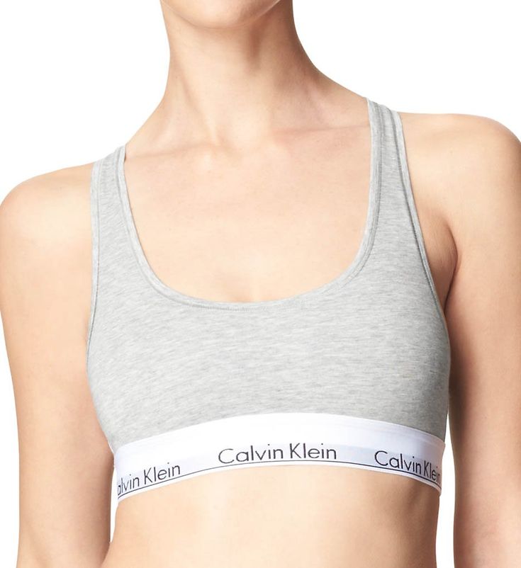 This soft bra offers light support and features the repeating Calvin Klein logo on the elastic underband. Wireless cups are lined with same fabric for gentle support. Elastic underband provides additional support and has the repeated Calvin Klein logo. Tall center front. Sewn-on elastic along top and bottom of sides for custom fit. Non-adjustable straps. Racerback for movement - great to wear under sleeveless tops. Pullover styling. Please Note: "Unlined" means that cups are unpadded. Calvin Kle Calvin Klein Bras, Calvin Klein Bra, Cotton Bralette, Comfy Bra, Soft Bra, Everyday Bra, Sleeveless Tops, Wireless Bra, Calvin Klein Woman