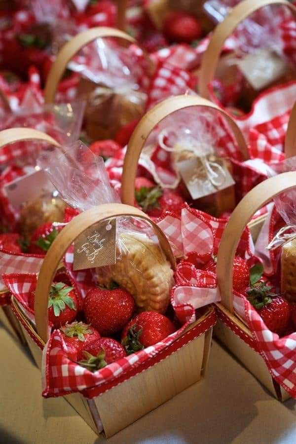 baskets filled with strawberries sitting on top of a table