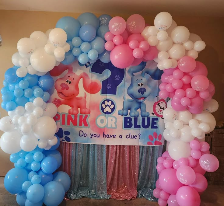 balloon arch with pink, blue and white balloons in front of the sign that says think or blue do you have a clue?