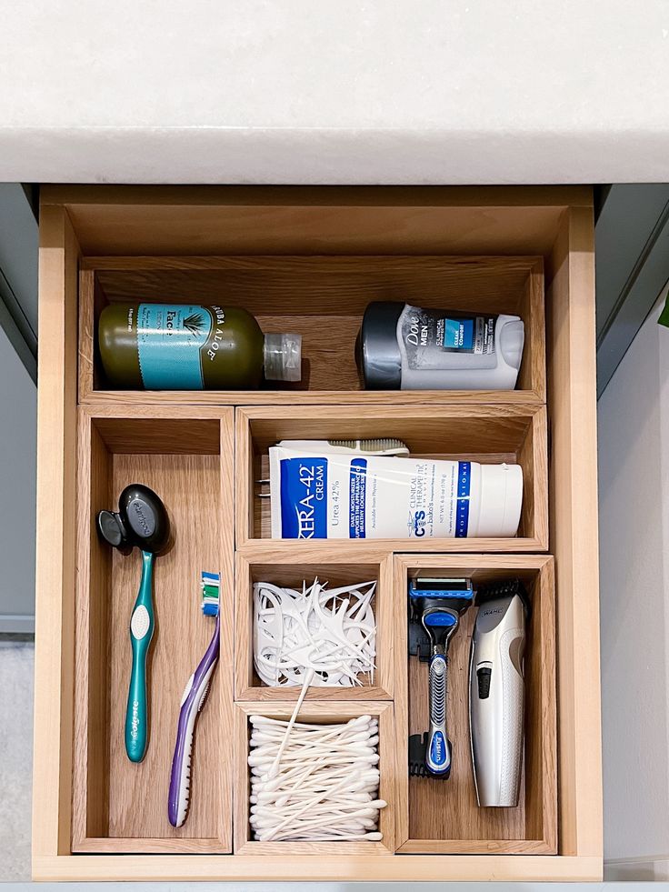 an organized drawer with toothbrushes, shampoos, and other bathroom items