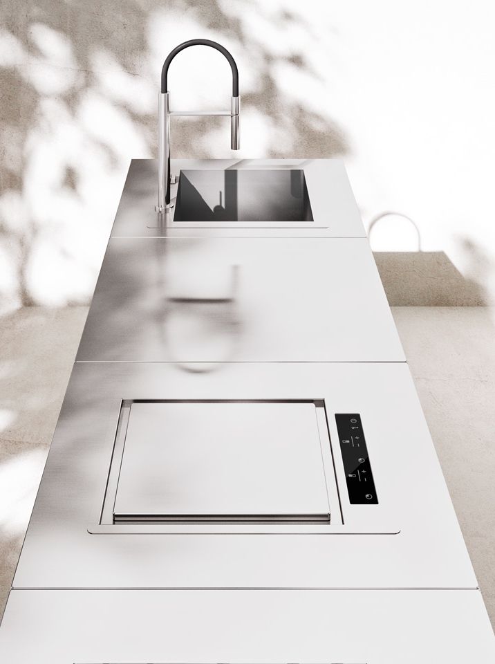 a white counter top with a sink and faucet