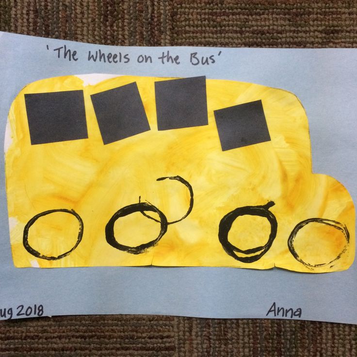 a child's drawing of a bus made from construction paper with the words wheels on the bus