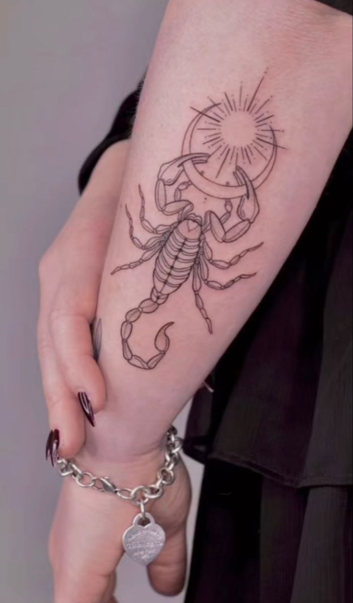 a woman with a scorpion tattoo on her arm