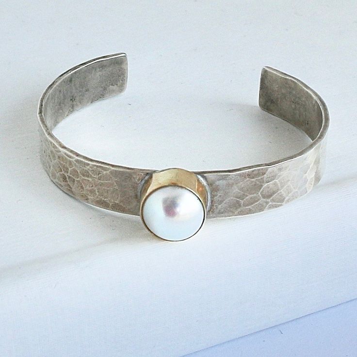 Please allow 3-5 weeks for this to be custom made and ship Sterling silver cuff with 14kt gold bezel and 1 Mother of Pearl Designed by Richard Schmidt Classic Hammered Adjustable Jewelry, Classic Adjustable Hammered Jewelry, Modern Hammered Cuff Jewelry, Richard Schmidt, Pearl Cuff, Hammered Sterling Silver, Pearl Design, Sterling Silver Cuff, Silver Cuff