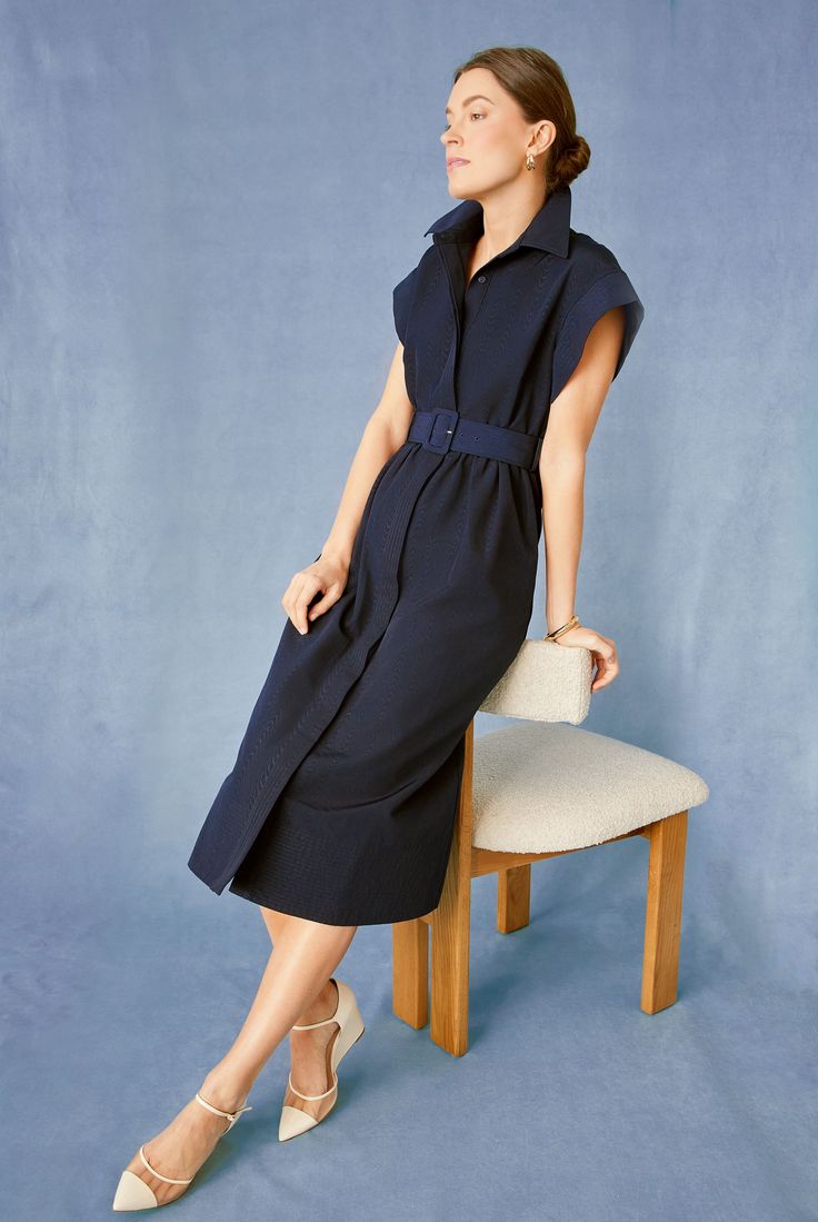 Elegant in its simplicity, the structured and ultra-ladylike Navy Chloe Dress is done in a textured cotton-blend fabric that is sure to turn heads for its design details. The moire pattern throughout and trapunto stitching on the sleeves, placket, and hemline complete this midi moment, making it feel extra special with minimal effort. Pair with heels or flats, sunnies or statement earrings, for day or night, and rest assured that you look fabulous! Spread collar Short wing sleeves Button front p Modern Structured Knee-length Dress, Elegant Cotton Dress For Work, Modern Structured Midi Dress, Elegant Cotton Workwear Dresses, Modern Knee-length Cotton Dress, Modern Fitted Cotton Dresses, Elegant Cotton Midi Dress For Work, Structured Spring Workwear Dresses, Modern Cotton Dresses For Daywear