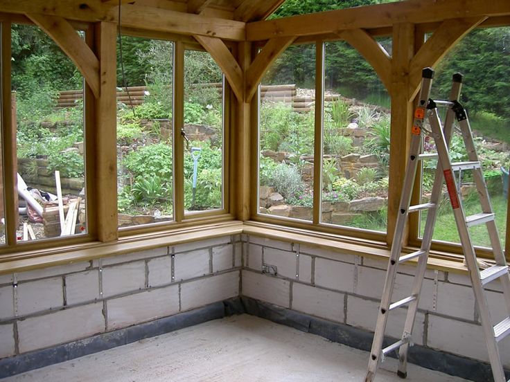 the inside of a house being built with windows and ladders in front of it