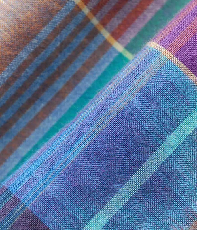 a close up shot of the fabric on a plaid shirting material that is multicolored