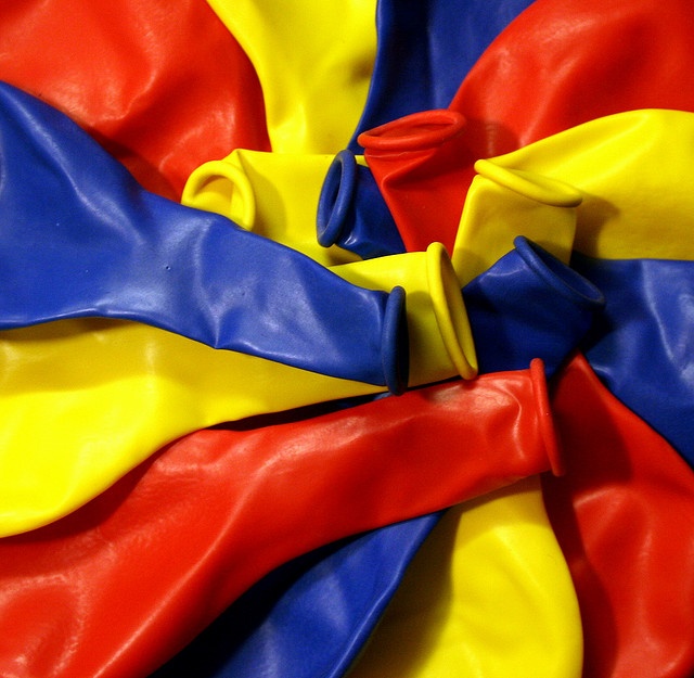 a close up view of the colors of a flag, including red, yellow and blue