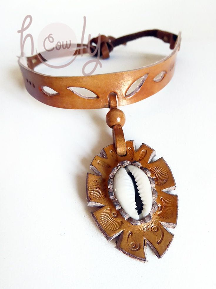 This beautiful handmade leather necklace is made from the finest quality brown leather. It has beautiful sea shell incorporated into it's design. It is adjustable at the back so it fits all sizes. The product is new and can be shipped immediately. Brown Pendant Jewelry For Beach, Brown Adjustable Length Jewelry For Beach, Brown Pendant Jewelry For The Beach, Brown Adjustable Length Jewelry For The Beach, Artisan Adjustable Cowrie Shell Jewelry, Artisan Cowrie Shell Jewelry, Handmade Brown Shell As Gift, Handmade Brown Shell As A Gift, Adjustable Brown Shell For Beach