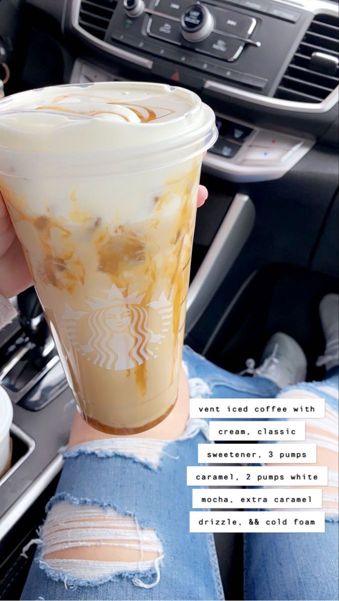 a woman holding up a cup of iced coffee in her hand with the words starbucks on it