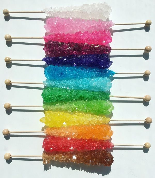 there are many different colored lollipops on the skewers