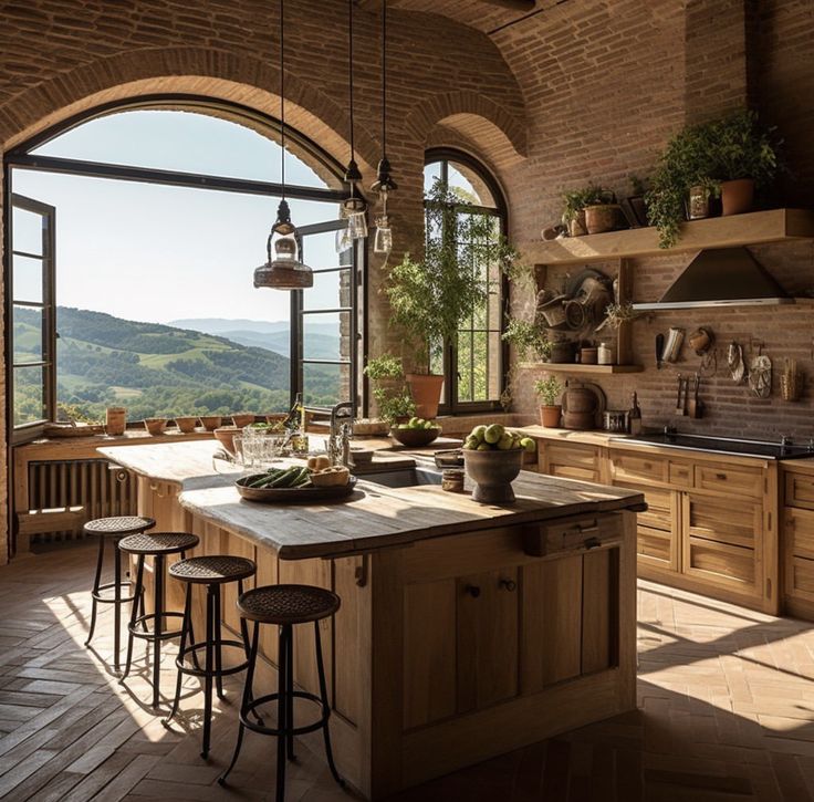 a kitchen with an arched window overlooking the hills and valleys is featured in this magazine