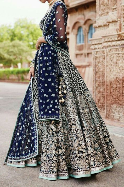 a woman in a blue and white lehenga