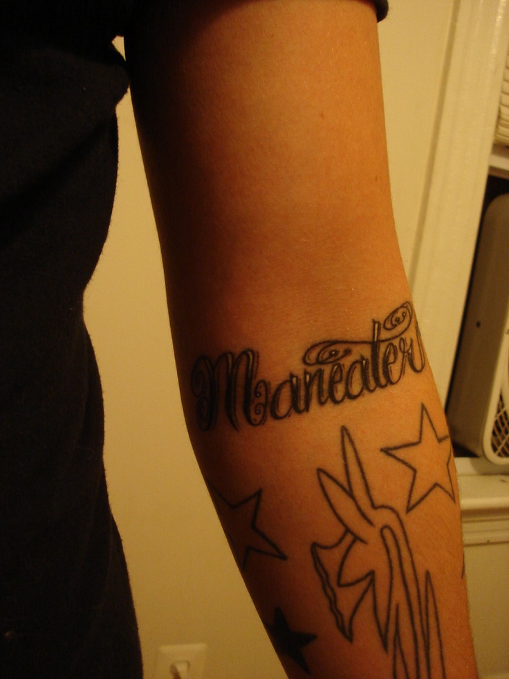 a woman with a tattoo on her arm that says merremater and stars