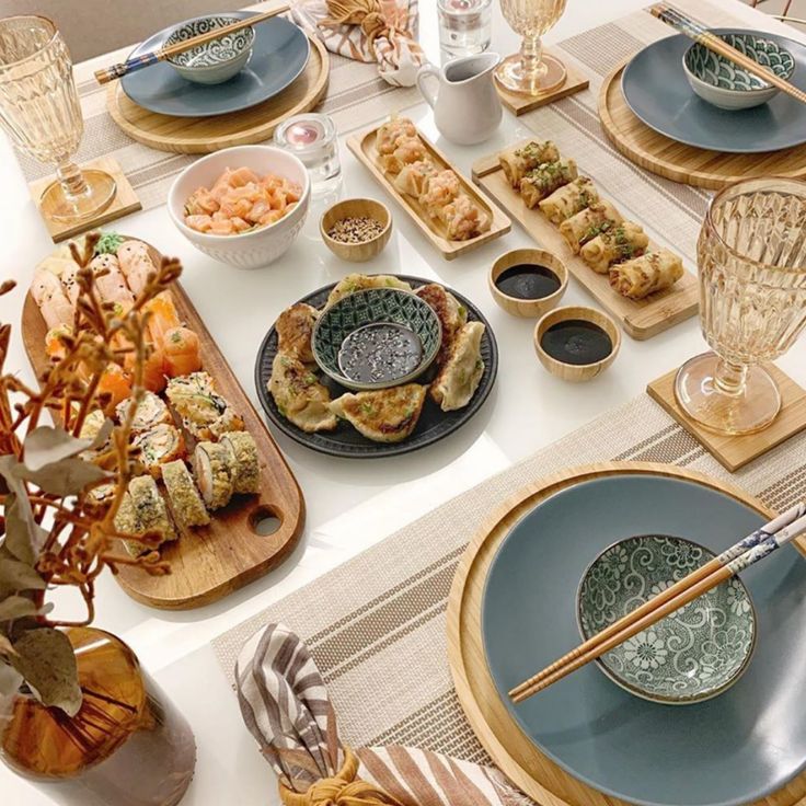 a table set with plates, bowls and utensils