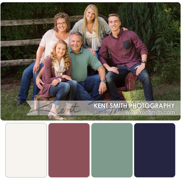 a family sitting on a bench in front of a fence with their arms around each other