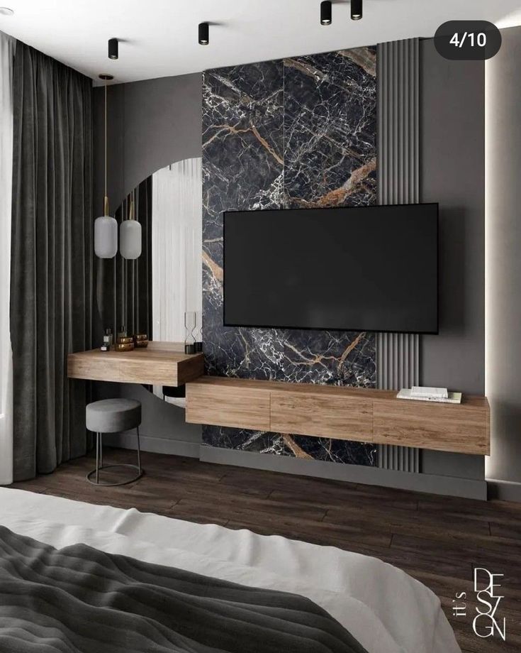 a bedroom with a large tv on the wall