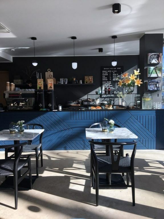 the interior of a restaurant with tables and chairs