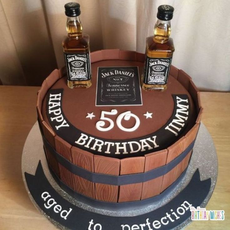 a birthday cake with two bottles of whiskey on top