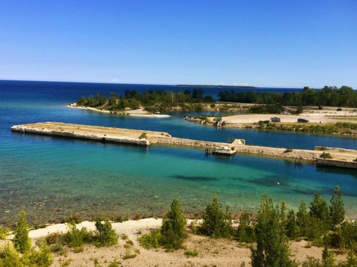 the water is crystal blue and clear with boats docked at it's docks