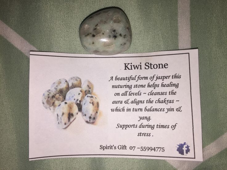 a sign with some kind of stone on it next to a piece of paper that says kiwi stone