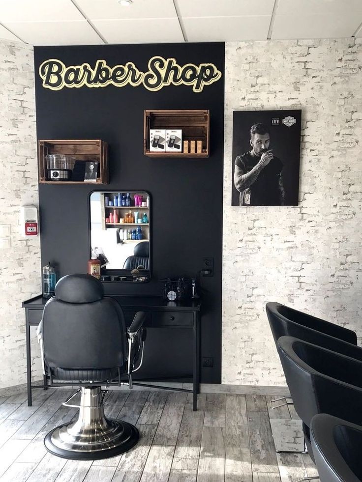 there is a barber shop with chairs in the room and pictures on the wall behind it