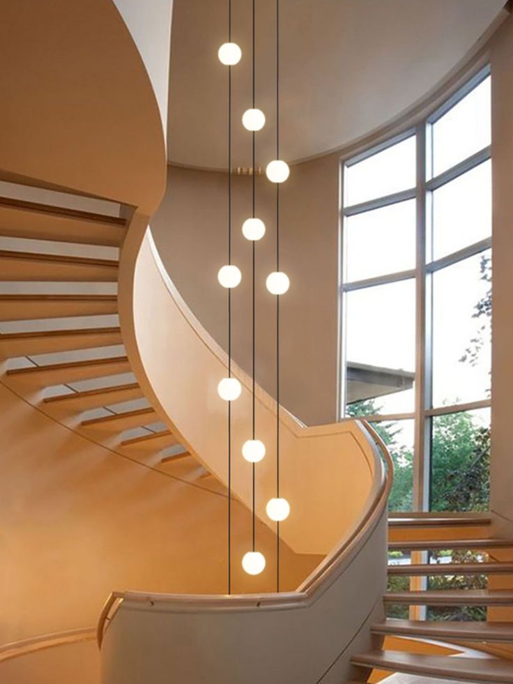 a spiral staircase with lights hanging from it