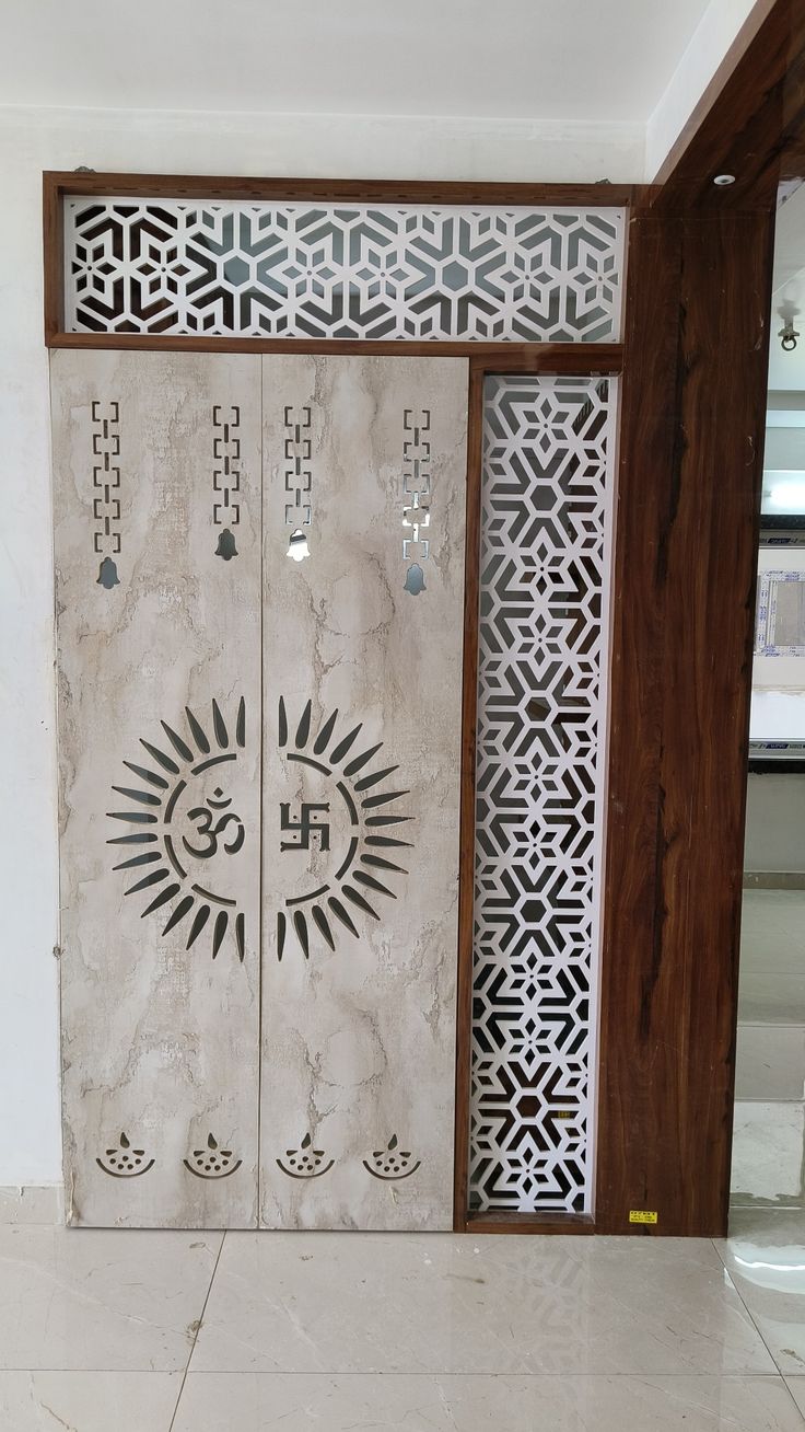 two white doors with designs on them in a room that has tile floors and walls