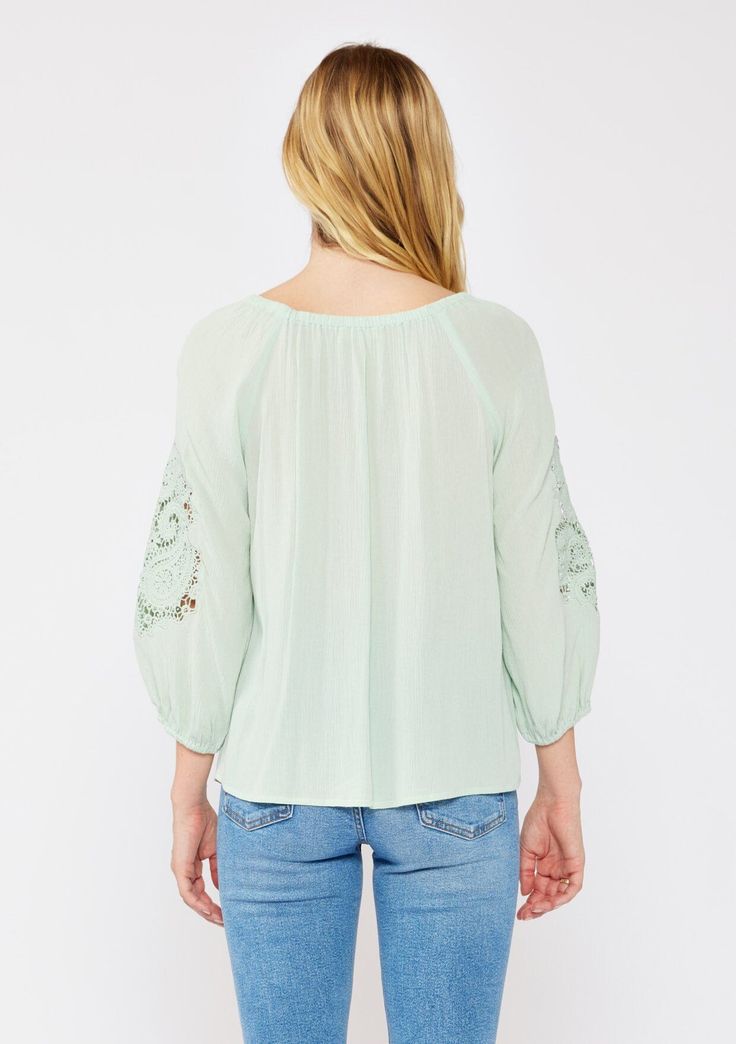 A casual bohemian blouse with a beautiful paisley lace detail on sleeve. Relaxed, flowy fit Elastic on or off-shoulder neckline 3/4 length sleeves Elastic wrist cuff Lace detail Flowy bohemian blouse Dry clean recommended or hand wash cold Step into effortless bohemian chic with this versatile blouse, beautifully designed with intricate paisley lace detailing. The relaxed fit effortlessly flatters any figure, while the elastic round neckline offers different styling options. Wear it as-is for a Summer Blouse With 3/4 Blouson Sleeves, Summer Blouse With Blouson Sleeves And 3/4 Sleeve, Summer Tops With Blouson 3/4 Sleeves, Spring Bohemian Half-sleeve Blouse, Spring Bohemian Half Sleeve Blouse, Flowy Half Sleeve Blouse For Spring, Bohemian Half Sleeve Blouse For Spring, Bohemian Spring Tops With 3/4 Sleeves, Summer Long Sleeve Off-shoulder Top With Blouson Sleeves