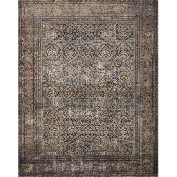 an area rug with various colors and patterns on the carpet, including blue, brown, beige