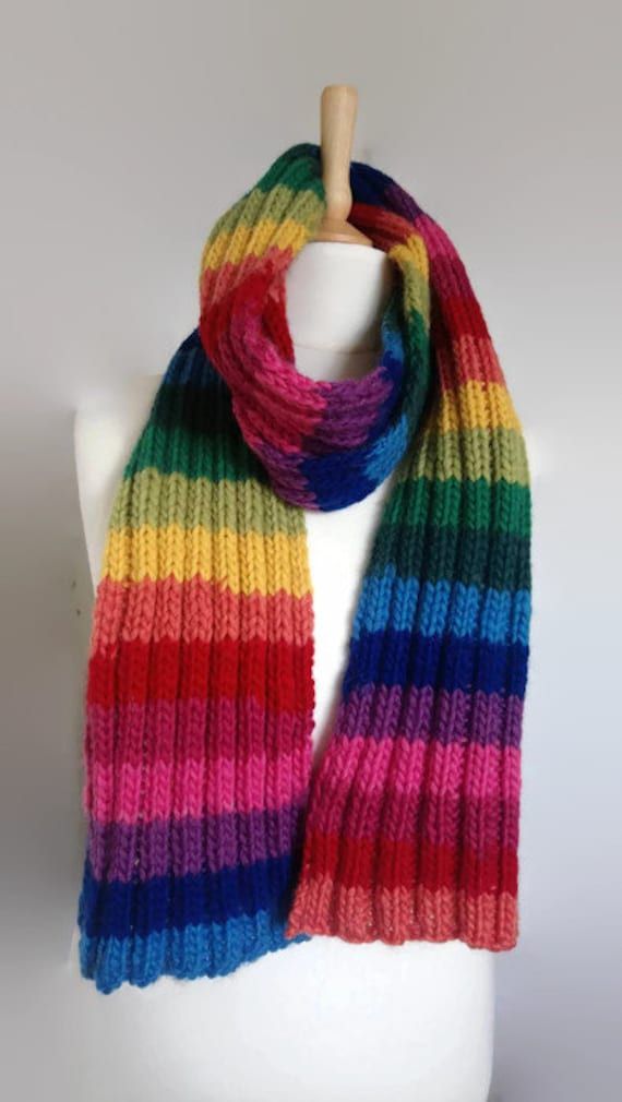 a multicolored knitted scarf on a mannequin