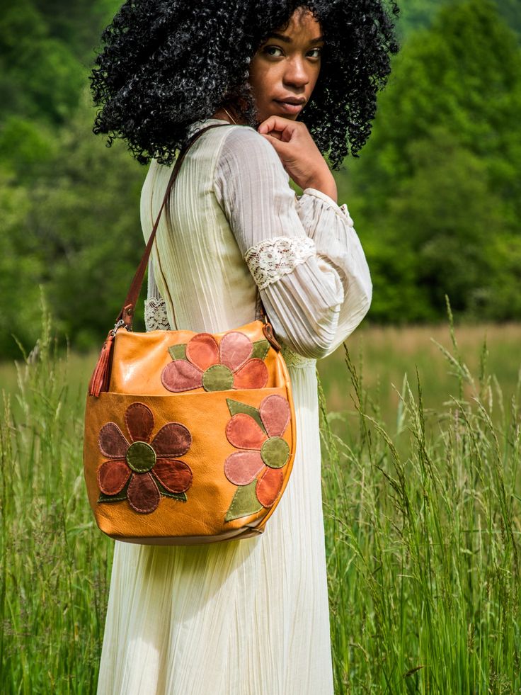 Product Description: Y'all! I am OBSESSED with this bag: The Marie! In LIMITED RUN Flower Power Eco-Tanned leather with coordinating leather tassel! This leather is everything. Comes unlined with an internal phone pocket, or choose to add a lining to your new beauty here: https://inbluehandmade.com/products/add-a-lining-to-my-new-bag-41075?_pos=1&_psq=add%20a%20lining&_ss=e&_v=1.0&variant=44005823283433 Hurry! These are limited-run! Please allow 3-4 weeks for us to make this beautiful bag by han Limited Run, Classic Bags, The 60s, Leather Tassel, So Proud, Beautiful Bags, New Bag, Bourbon, Flower Power