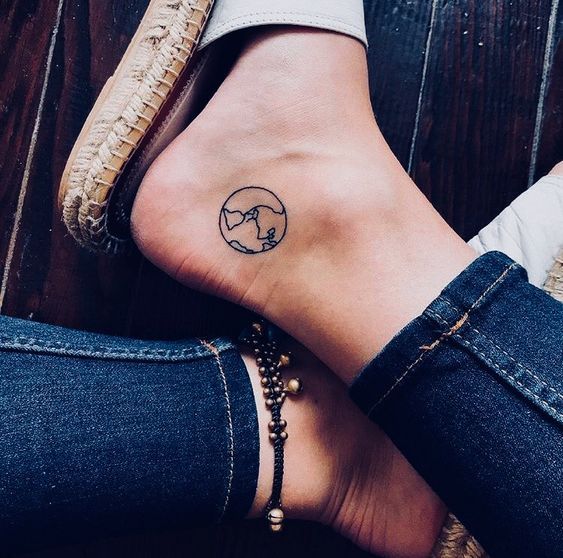 a woman's foot with a small tattoo on the side of her leg and ankle