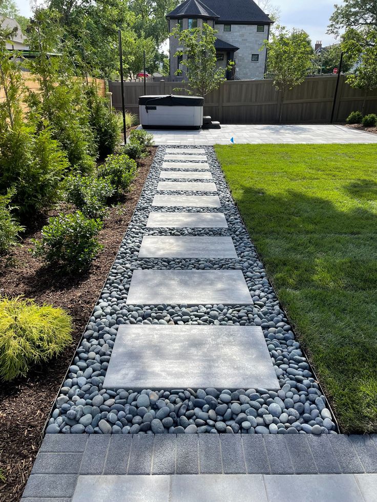 a stone path in the middle of a yard