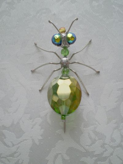 a glass beaded insect sitting on top of a table