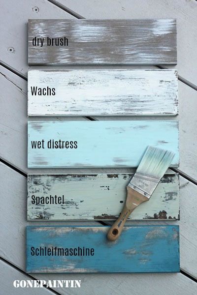 a paint brush sitting on top of a wooden pallet with words written below it