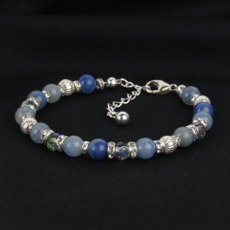 You'll love the unique design and beautiful colors in our silver aventurine bracelet. Each gemstone varies from medium to light blue. We've paired sterling silver beads and rhinestones for a lovely shine. Materials: sterling sliver lobster claw and sterling silver 1.5 inch extension Beads: blue aventurine gemstones, sterling corrugated beads, sterling plated rhinestone beads, and glass beads Width: 6mm Aquamarine Beaded Bracelet Jewelry, Elegant Amazonite Beaded Bracelets, Adjustable Beaded Aquamarine Bracelets, Silver Bracelets With Amazonite And Natural Stones, Silver Spiritual Beaded Bracelets With Stones, Blue Amazonite Jewelry With Polished Beads, Silver Amazonite Bracelet As Gift, Spiritual Silver Beaded Bracelets With Stones, Silver Amazonite Bracelet For Gift